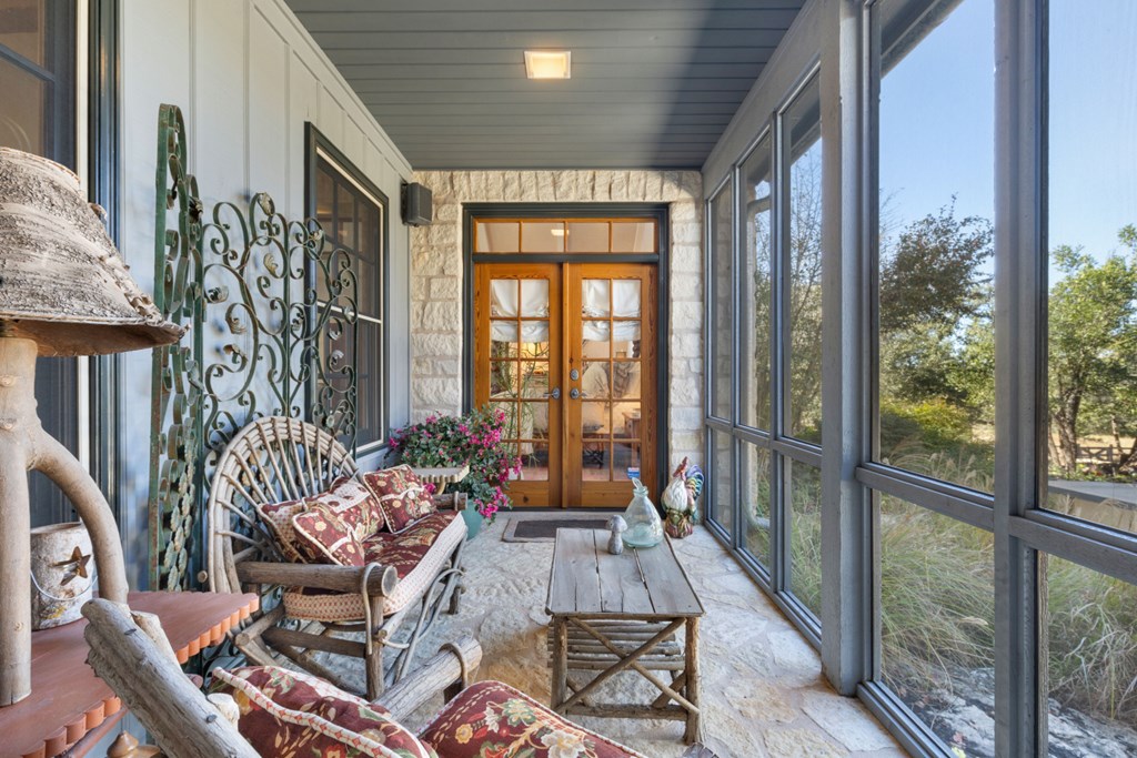 1129 Triple Creek Road Fredericksburg, TX 78624 - Photo 35 of 78 a living room with furniture and a floor to ceiling window