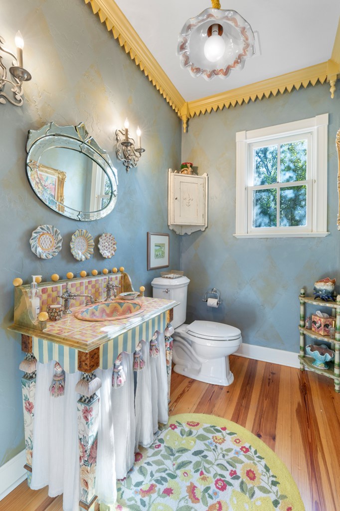 1129 Triple Creek Road Fredericksburg, TX 78624 - Photo 47 of 78 a bathroom with a sink a toilet and mirror