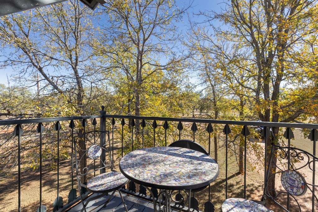 1129 Triple Creek Road Fredericksburg, TX 78624 - Photo 55 of 78 a view of balcony with furniture and wooden floor