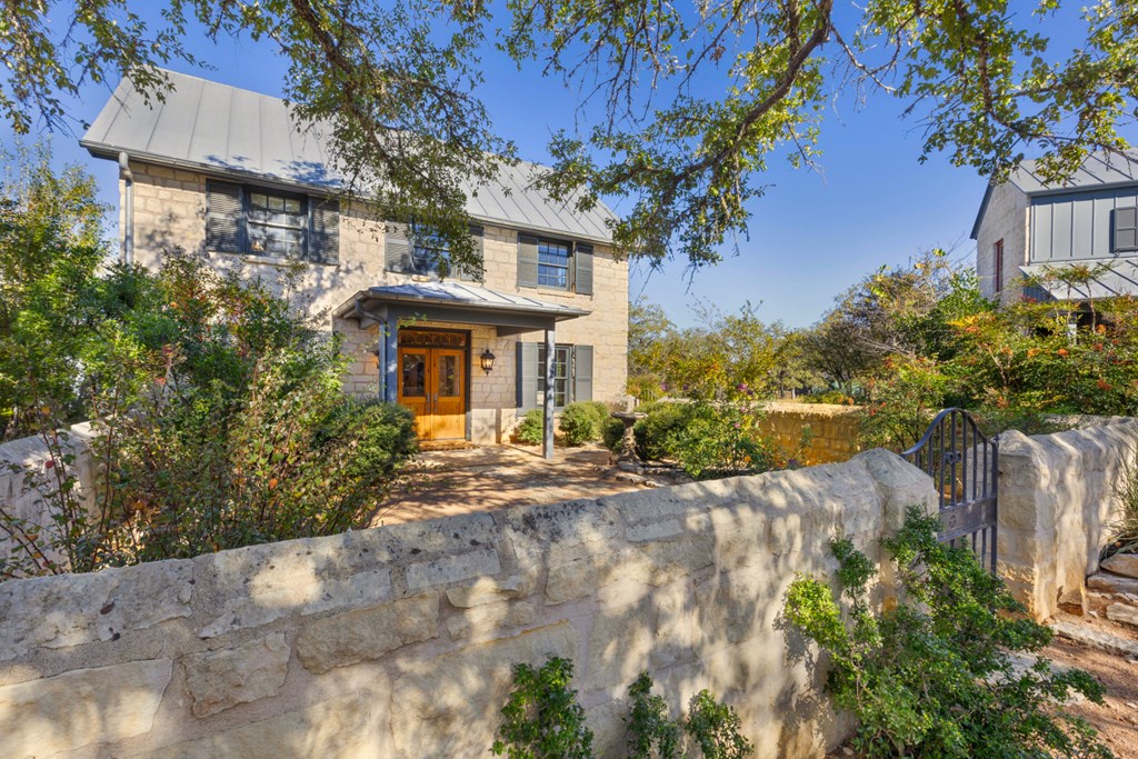 1129 Triple Creek Road Fredericksburg, TX 78624 - Photo 7 of 78 a front view of a house with a yard and a garage