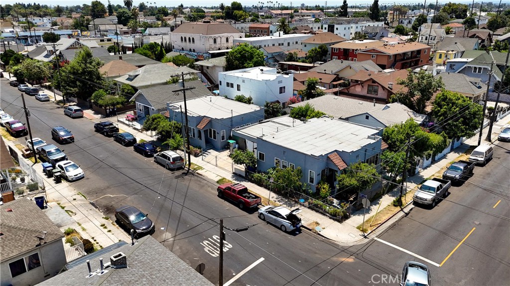 an aerial view of multiple houses with yard