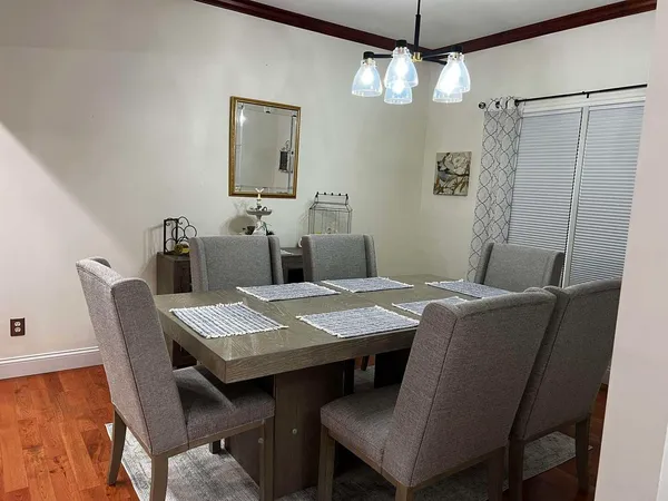 a view of a dining room with furniture and wooden floor