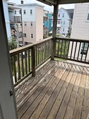 a balcony with wooden floor