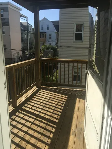 a view of balcony with wooden floor