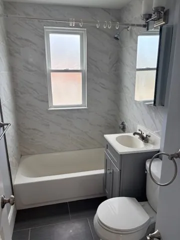 a bathroom with a sink toilet and bathtub