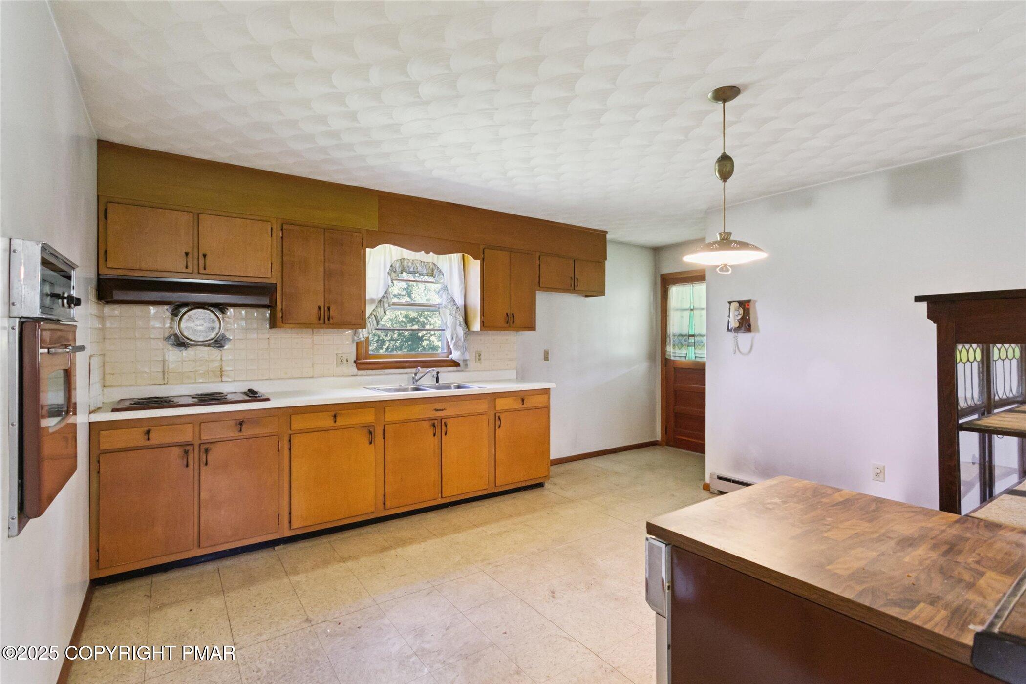 145 Sweet Arrow Lake Road Pine Grove, PA 17963 - Photo 14 of 38 a kitchen with granite countertop a sink stainless steel appliances and cabinets