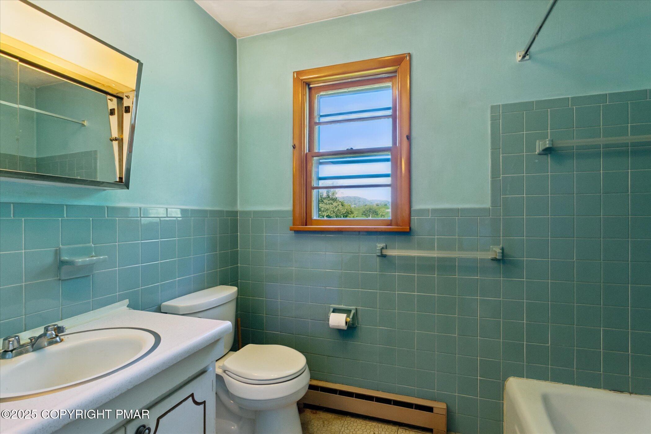 145 Sweet Arrow Lake Road Pine Grove, PA 17963 - Photo 18 of 38 a bathroom with a sink a toilet and mirror