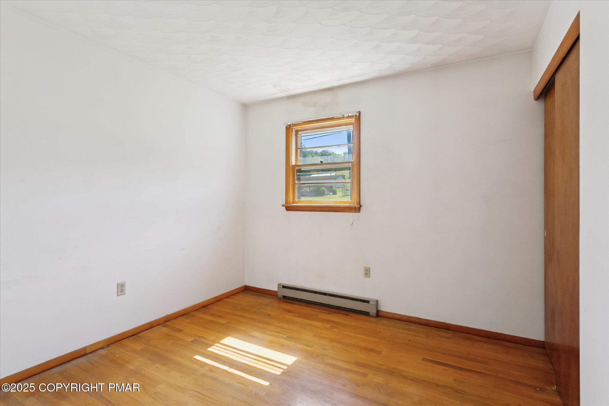 145 Sweet Arrow Lake Road Pine Grove, PA 17963 - Photo 21 of 38 a view of an empty room with wooden floor and a window