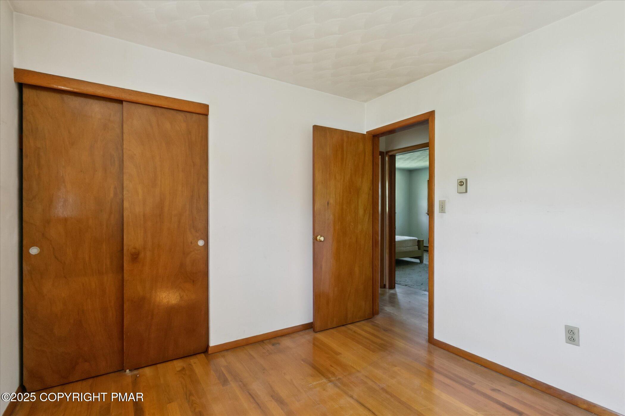145 Sweet Arrow Lake Road Pine Grove, PA 17963 - Photo 22 of 38 a view of an empty room with wooden floor and closet