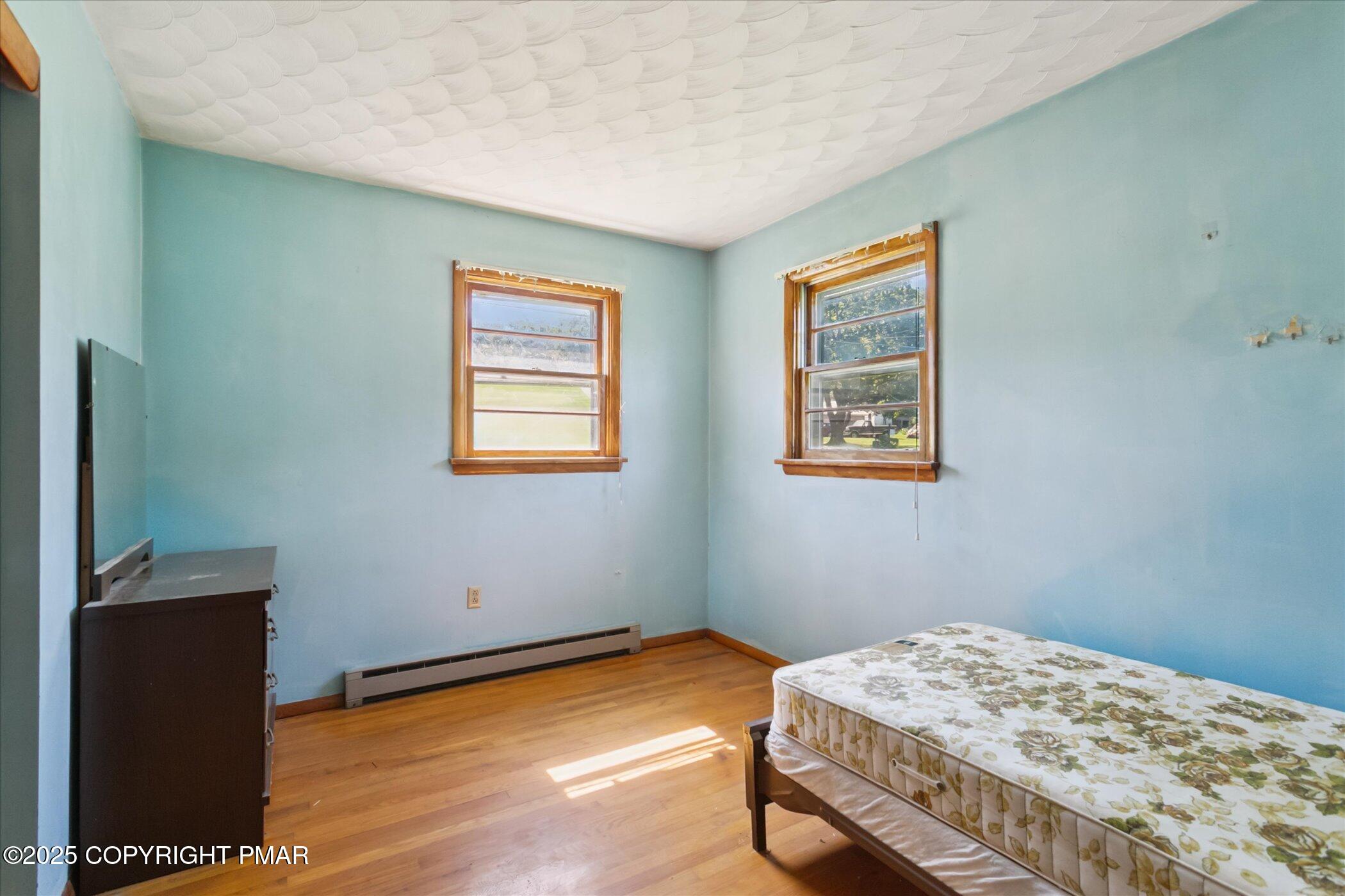 145 Sweet Arrow Lake Road Pine Grove, PA 17963 - Photo 23 of 38 a bedroom with a bed and wooden floor