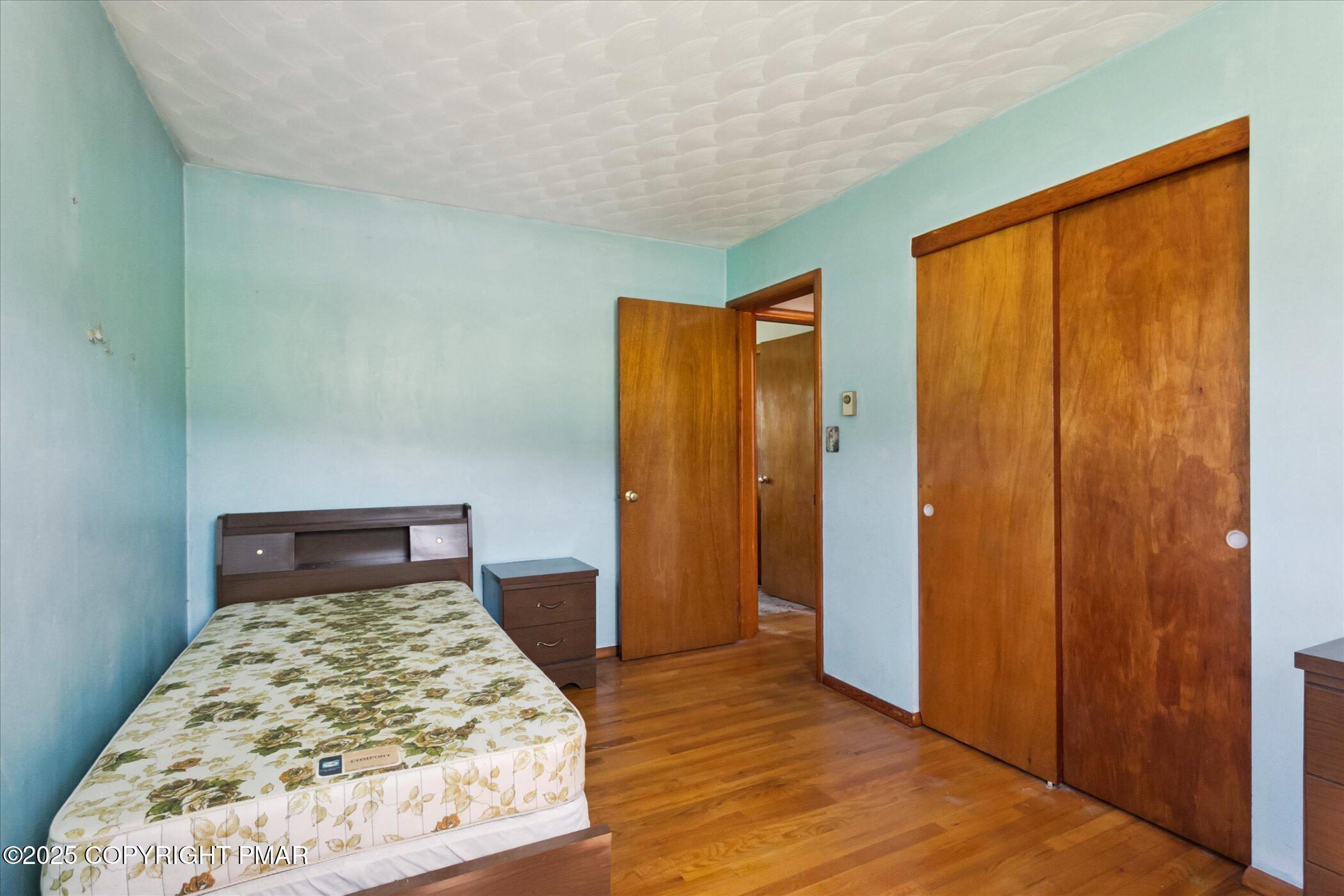 145 Sweet Arrow Lake Road Pine Grove, PA 17963 - Photo 24 of 38 a bedroom with a bed and wooden floor