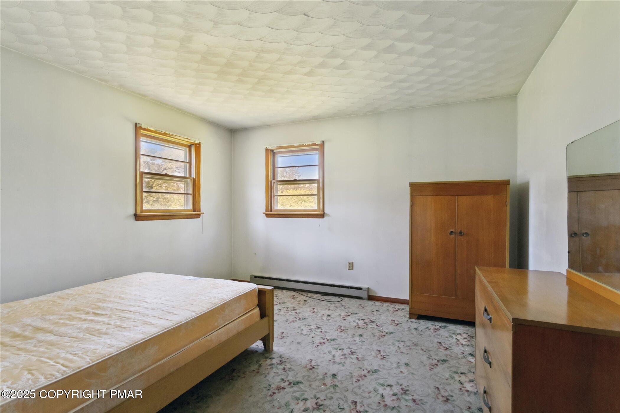 145 Sweet Arrow Lake Road Pine Grove, PA 17963 - Photo 25 of 38 a bedroom with a bed and wooden floor
