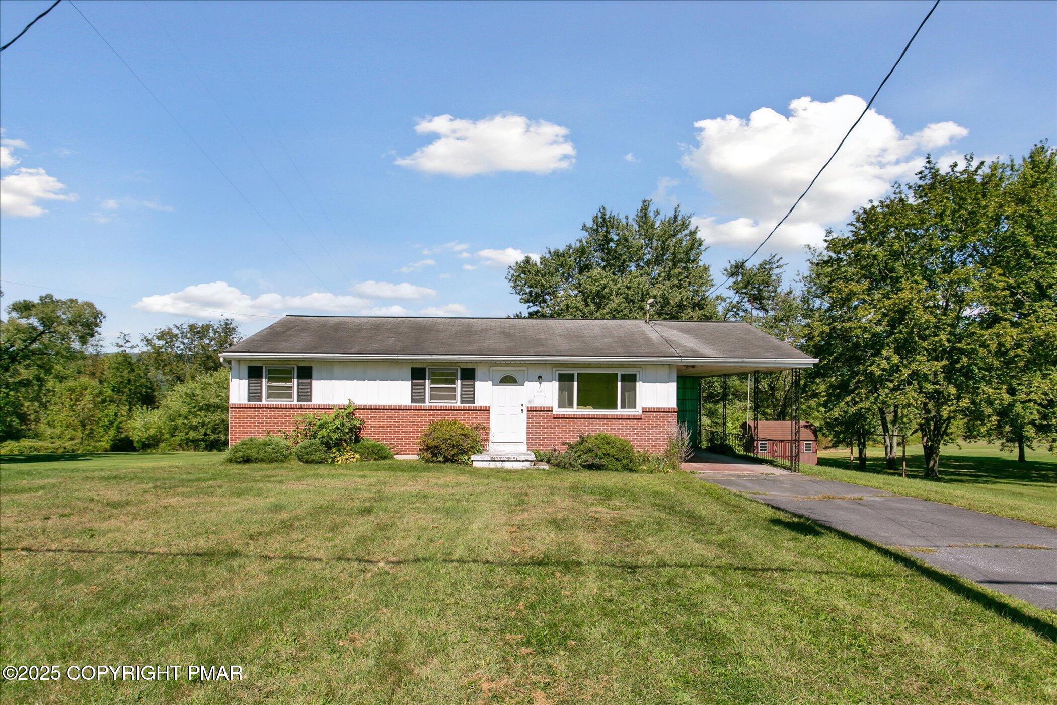 145 Sweet Arrow Lake Road Pine Grove, PA 17963 - Photo 4 of 38 a front view of a house with a garden