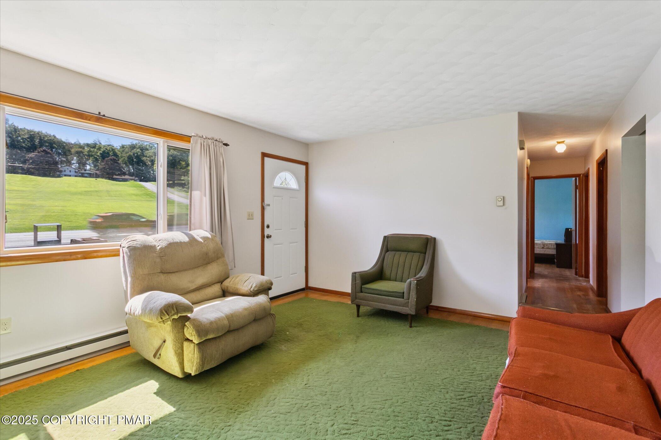145 Sweet Arrow Lake Road Pine Grove, PA 17963 - Photo 10 of 38 a living room with furniture and a floor to ceiling window