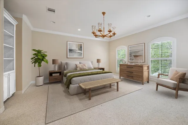a spacious bedroom with bed and a chandelier