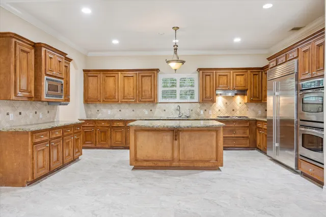 a kitchen with stainless steel appliances granite countertop a stove sink and cabinets