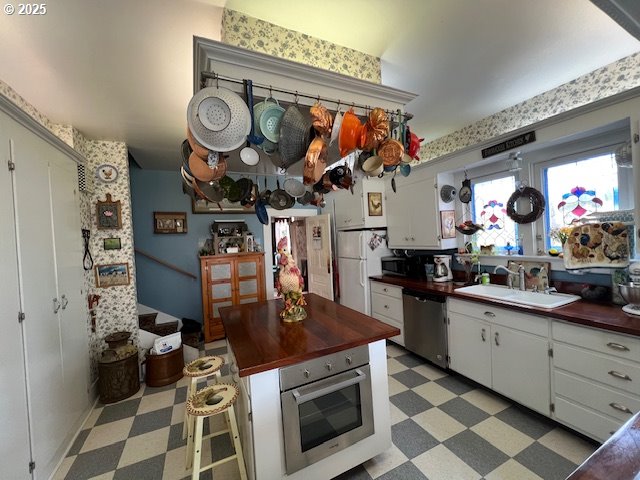 18 South Collier Street Coquille, OR 97423 - Photo 15 of 48 a kitchen with stainless steel appliances granite countertop a stove and a sink