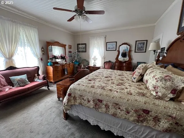 a bed sitting in a bedroom next to a window with tv