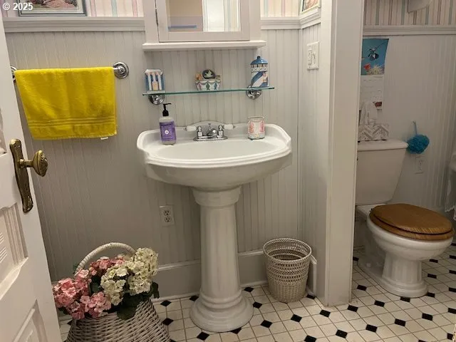 a bathroom with a toilet and a shower curtain
