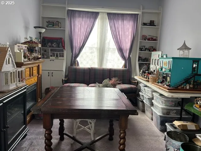 a living room with furniture a flat screen tv and a window