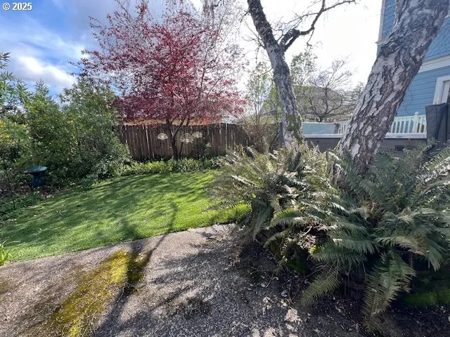 a view of a building with garden and trees
