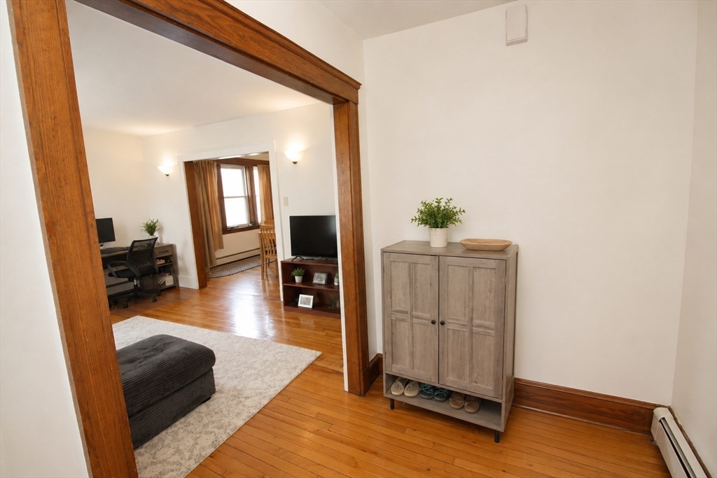 15 Herbert Road, Unit 15 Arlington, MA 02474 - Photo 4 of 9 a living room with furniture and a flat screen tv