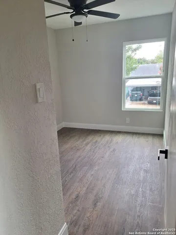 a view of room with window and hardwood floor