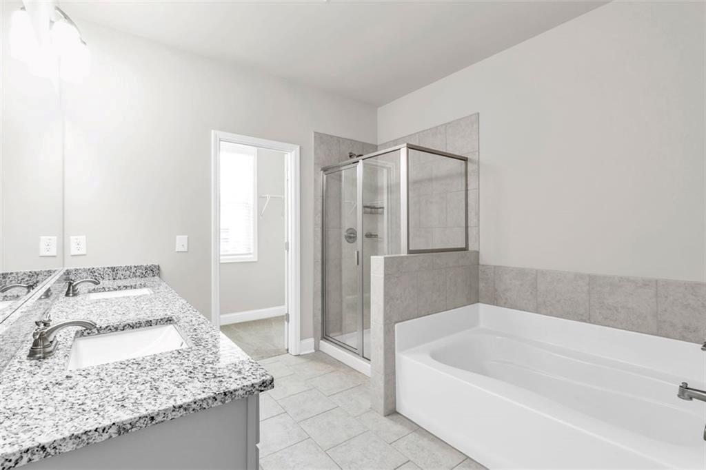 2340 Manor Pointe Drive Cumming, GA 30041 - Photo 22 of 45 a bathroom with a granite countertop tub sink and mirror