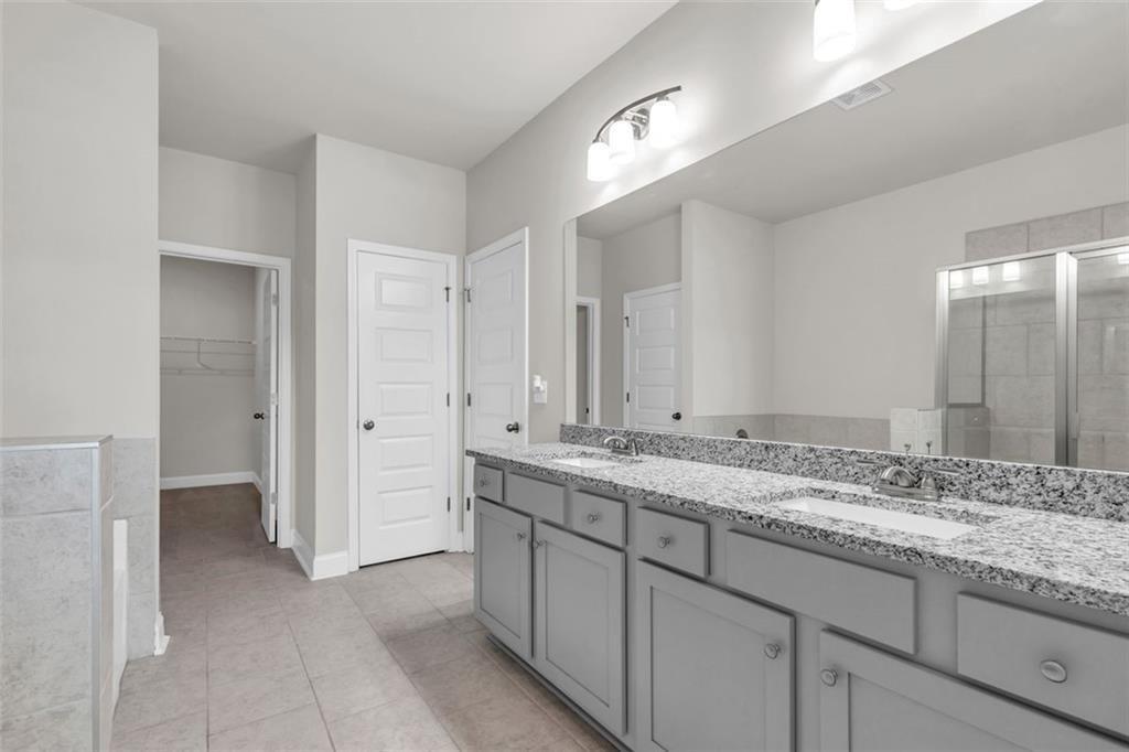 2340 Manor Pointe Drive Cumming, GA 30041 - Photo 24 of 45 a bathroom with a granite countertop sink and a mirror