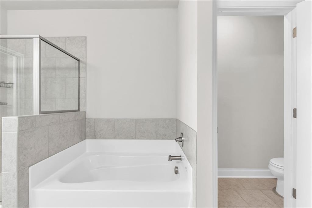 2340 Manor Pointe Drive Cumming, GA 30041 - Photo 25 of 45 a white bath tub sitting next to a toilet
