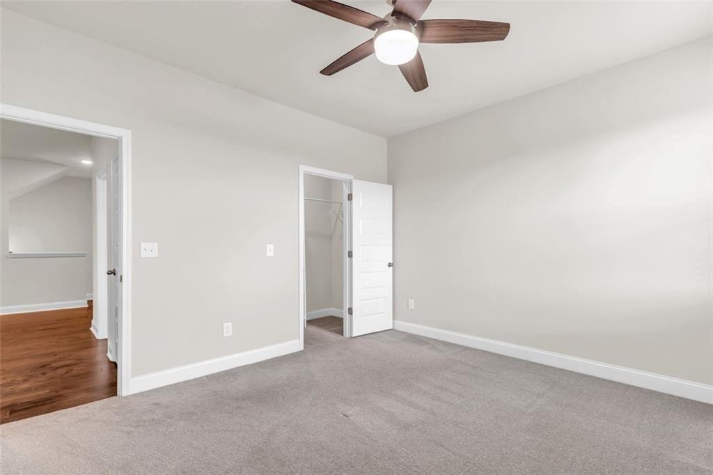 2340 Manor Pointe Drive Cumming, GA 30041 - Photo 31 of 45 an empty room with closet and a chandelier fan