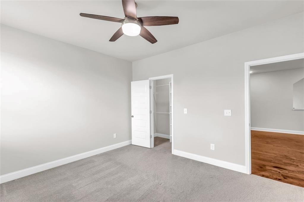 2340 Manor Pointe Drive Cumming, GA 30041 - Photo 34 of 45 an empty room with closet and a chandelier fan