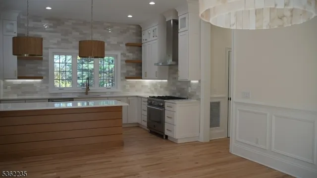 a kitchen with stainless steel appliances granite countertop a sink and a stove