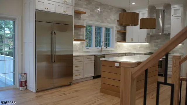a kitchen with cabinets and stainless steel appliances