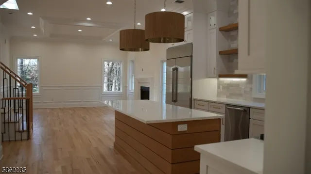 a kitchen with stainless steel appliances a refrigerator and a stove top oven