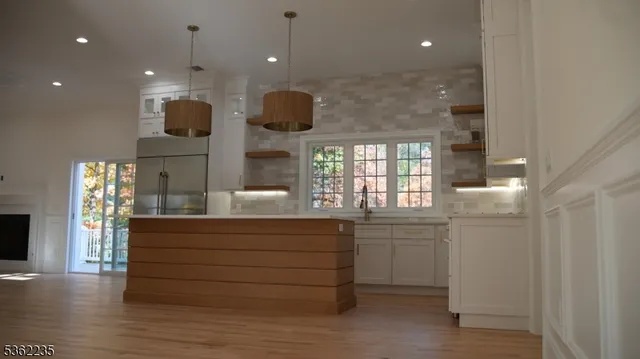 a kitchen with a wooden floor and window
