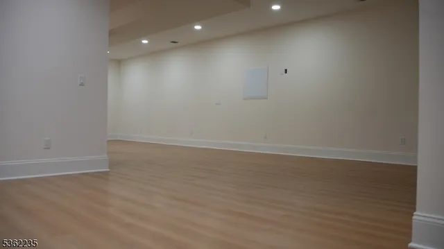 a view of room with wooden floor