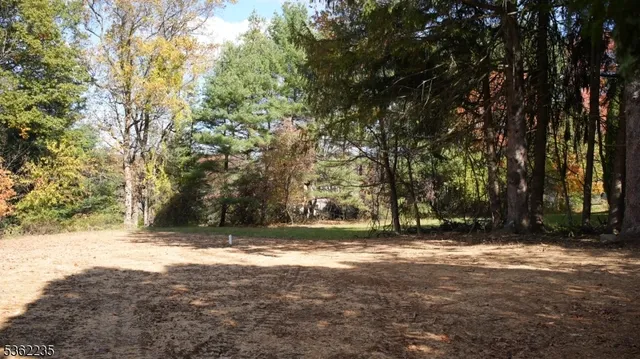 a view of tree with wooden fence