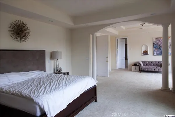a bedroom with a bed and a couch