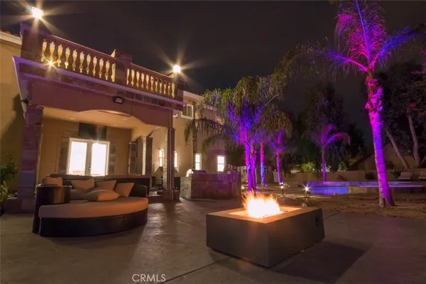 a front view of a house with a yard and outdoor seating