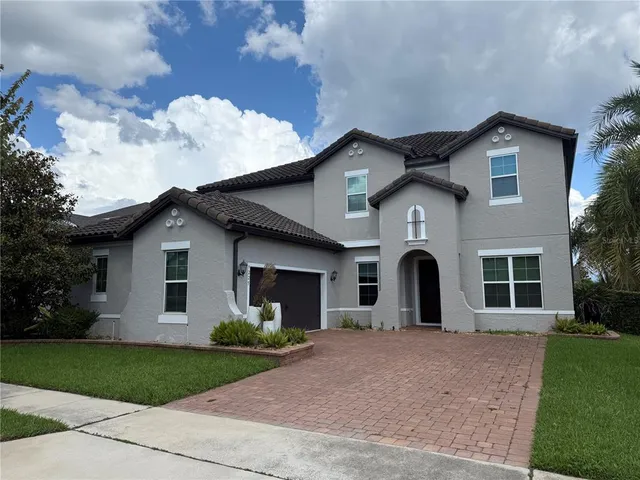 a front view of a house with a garden and yard