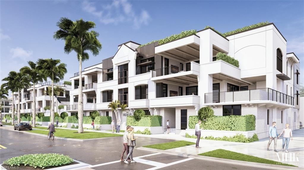 a view of a building with a yard and plants