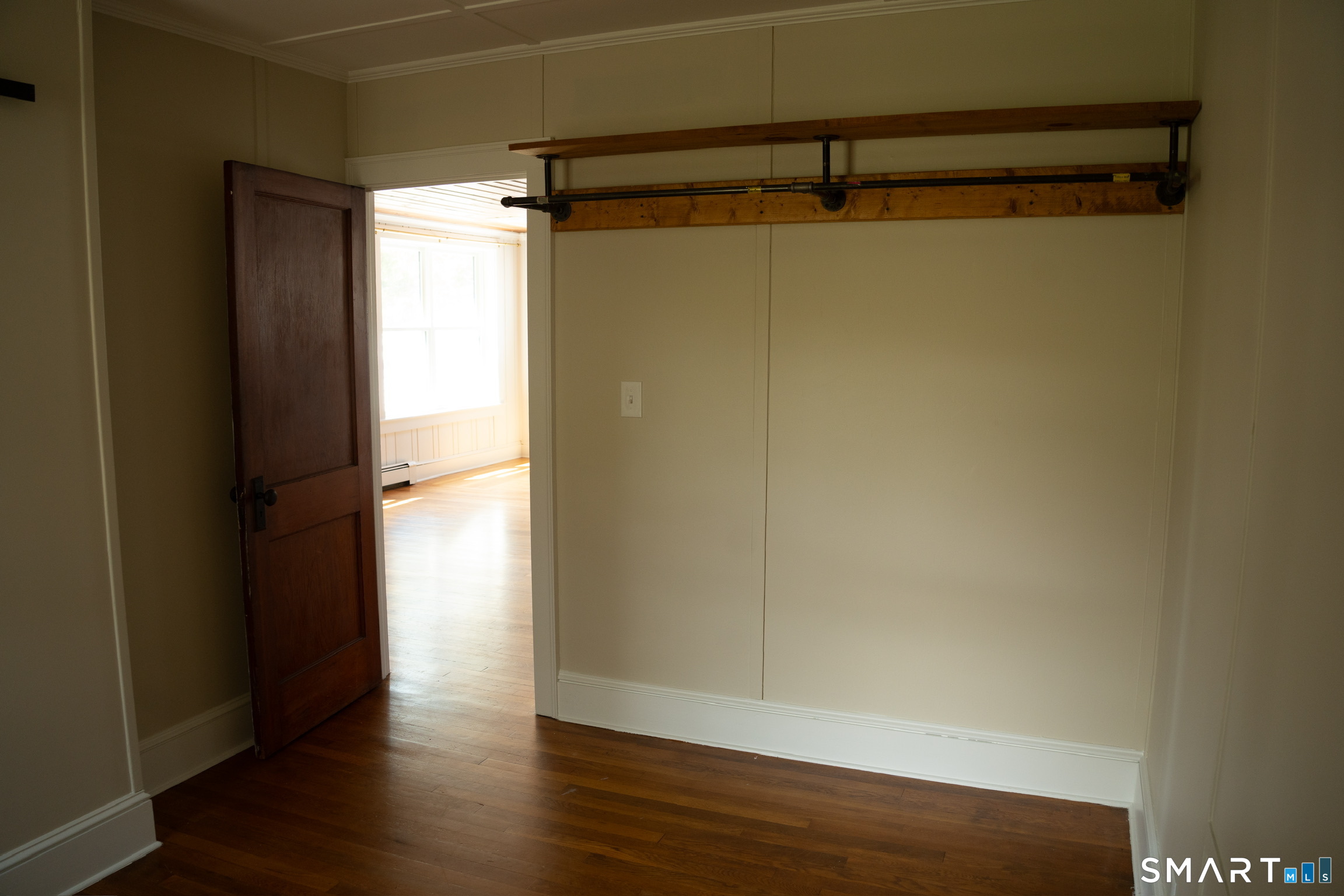 97 Candlewood Road Groton, CT 06340 - Photo 17 of 26 a view of a room with wooden floor and a window