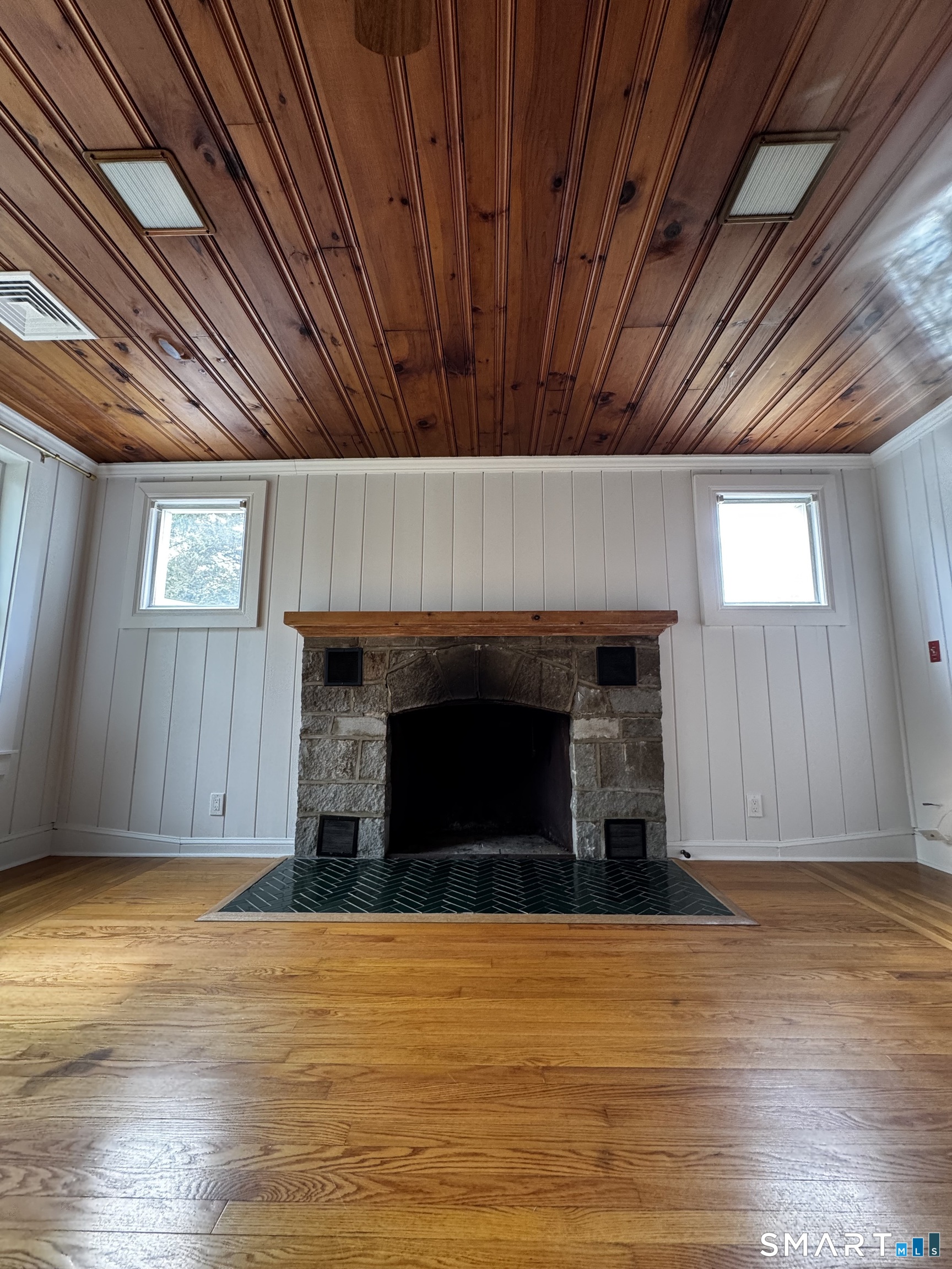 97 Candlewood Road Groton, CT 06340 - Photo 3 of 26 a view of empty room with wooden floor and fireplace
