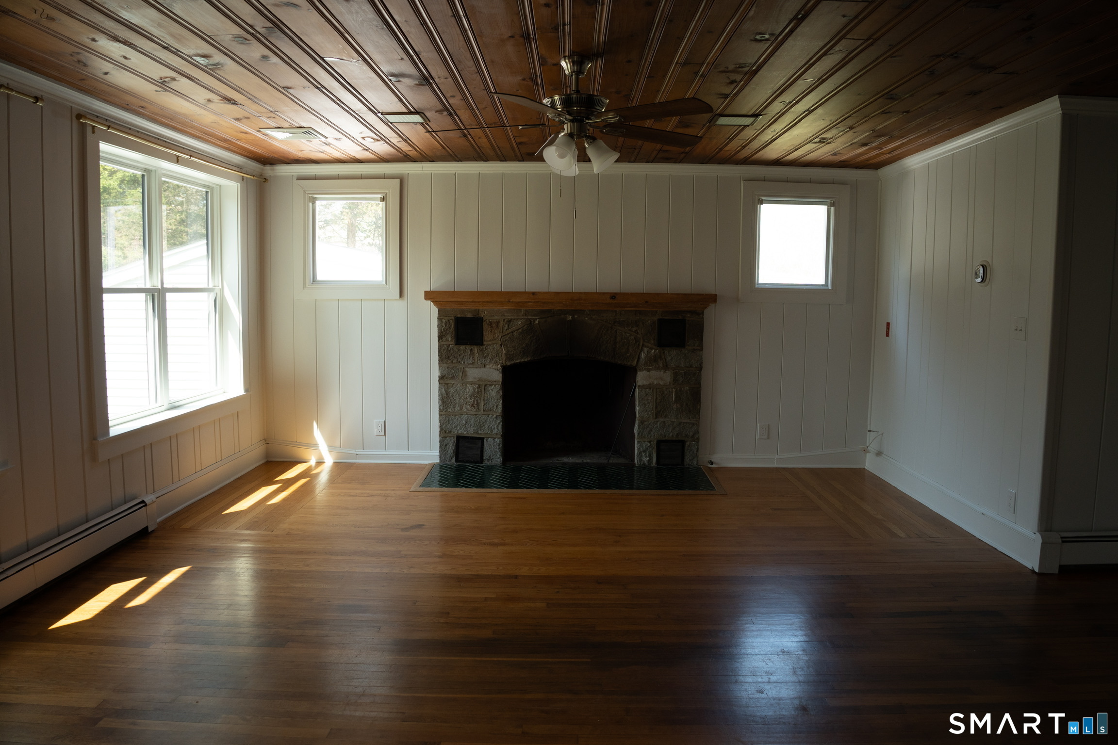 97 Candlewood Road Groton, CT 06340 - Photo 5 of 26 a view of an empty room with wooden floor and a window