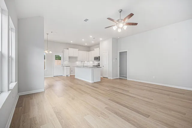a view of kitchen with kitchen island and stainless steel appliances