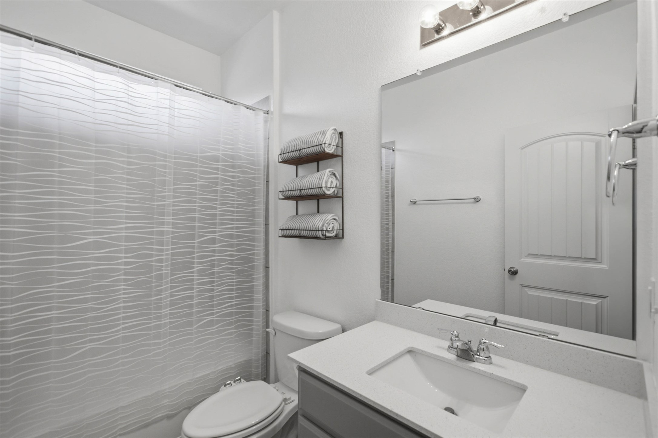 2413 Bridges Ranch Road Georgetown, TX 78628 - Photo 22 of 31 A pristine bathroom featuring a vanity with ample counter space and a modern shower with a textured curtain.