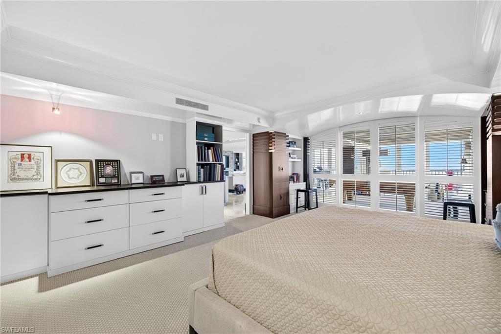 5601 Turtle Bay Drive, Unit 2104 Naples, FL 34108 - Photo 11 of 31 Bedroom featuring light carpet and crown molding
