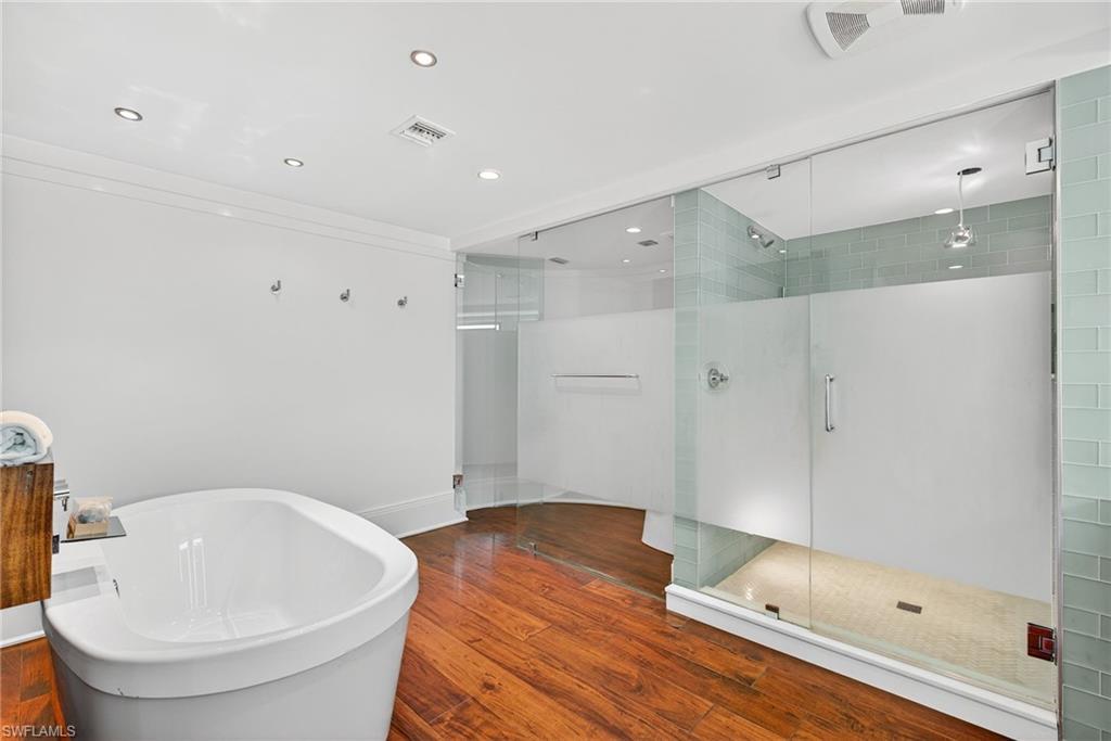 5601 Turtle Bay Drive, Unit 2104 Naples, FL 34108 - Photo 13 of 31 Full bathroom featuring a stall shower, a freestanding bath, recessed lighting, and wood finished floors