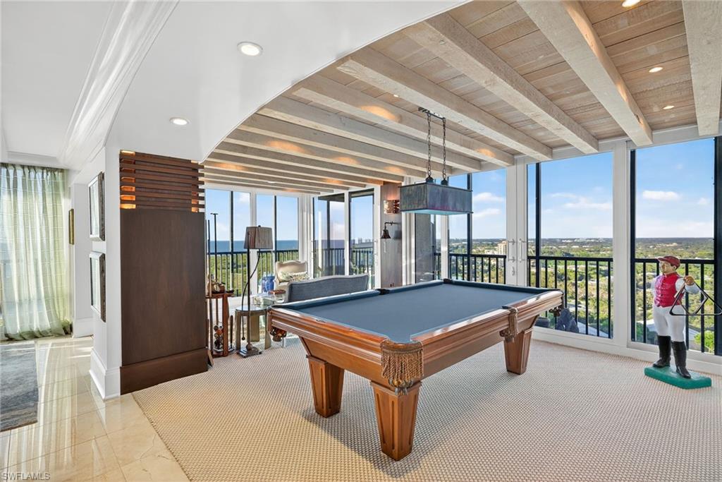 5601 Turtle Bay Drive, Unit 2104 Naples, FL 34108 - Photo 20 of 31 Rec room with pool table, expansive windows, plenty of natural light, recessed lighting, and a wood ceiling with exposed beams